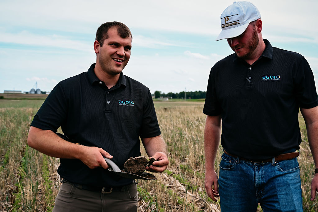 Two men farmers preforming a soil test on corn and cover crop field in Indiana